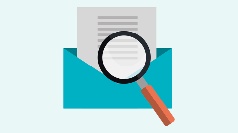 Magnifying glass over letter in envelope