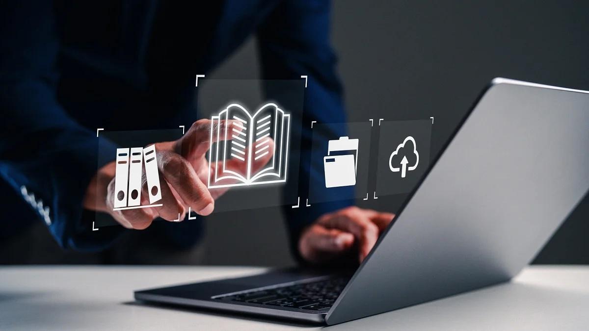 Person interacts with digital documents on laptop